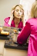 Woman Massaging Her Head In Mirror