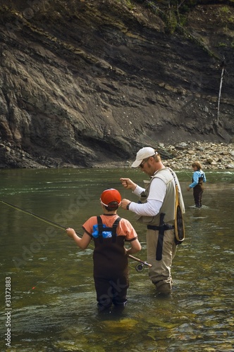 Photo: Father And Sons Fly Fishing In Mountain River Father And Sons Fly Fishing In Mountain River