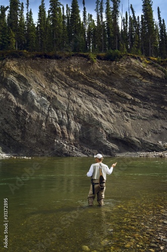 Photo: Man Fly Fishing In Mountain River Man Fly Fishing In Mountain River