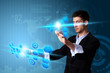 Man pressing modern touch screen buttons with a blue technology Man pressing modern touch screen buttons with a blue technology
