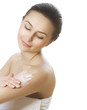 Beautiful Young Woman applying moisturizer. Spa concept Beautiful Young Woman applying moisturizer. Spa concept