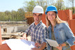 Engineers on construction site with plan