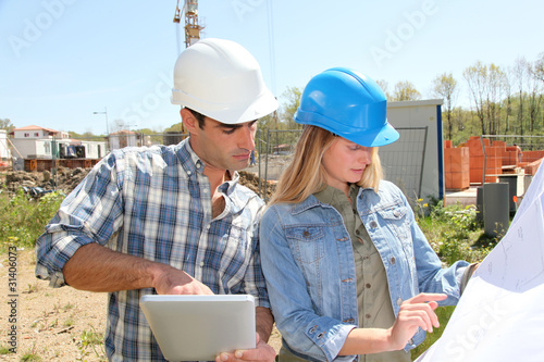 Foto: Engineers on construction site with plan Engineers on construction site with plan