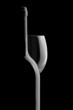 Elegant wine bottle and wine glass in a black background