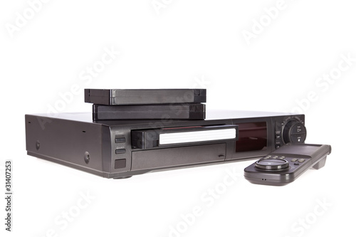 Photo: Old Video Cassette Recorder and tapes isolated on white Old Video Cassette Recorder and tapes isolated on white
