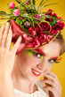 Beautiful young woman with creative flower cap. Artistic makeup