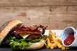 Bacon and cheeseburger with chips.