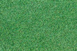 Background texture with fake grass in a public children playgrou