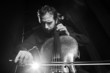 Photo: Cellist musician playing classical music on cello on black Cellist musician playing classical music on cello on black