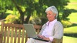 Video: Mature woman surfing on her laptop outdoors Mature woman surfing on her laptop outdoors