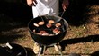Man cooking hamburgers on barbecue