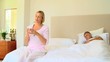 Video: Young woman in bedroom taking a pill for a headache Young woman in bedroom taking a pill for a headache