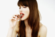beautiful woman biting a bar of chocolate in a sexy way