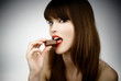 sexy girl eating a bar of chocolate - studio shot