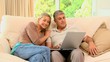 Cute couple using a laptop