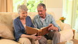 Mature couple looking at an album