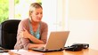 Blonde woman using a laptop