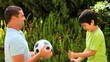 Video: Young boy and his father playing with a football Young boy and his father playing with a football