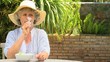 Mature woman drinking a glass of red wine outdoors