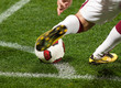 Soccer player kicking the ball from corner