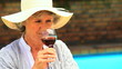 Woman tasting red wine outdoors