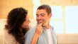 Young woman giving a strawberry to her boyfriend