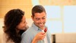 Woman taunting her boyfriend with a strawberry