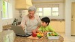 Woman teaching grandson to cook