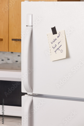 Photo: Note on refrigerator door Note on refrigerator door