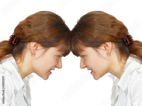 Photo: Woman facing her forehead with herself Woman facing her forehead with herself