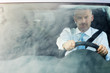 businessman driving car with sky reflections on windshield