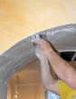 Men at work spreading plaster