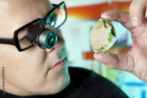 Photo: Jeweller appraising quality of diamond Jeweller appraising quality of diamond