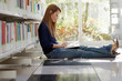 girl studying on floor in library