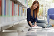 girl studying on floor in library