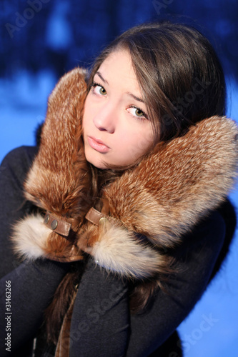 Photo: girl the teenager in fur mittens. girl the teenager in fur mittens.
