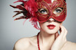 The beautiful young woman in a red mysterious venetian mask The beautiful young woman in a red mysterious venetian mask
