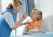 Photo : senior woman 90 years old being fed by a nurse