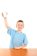 handsome blond boy raising hand with glass of milk