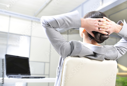 Photo: businesswoman resting in the arm-chair businesswoman resting in the arm-chair