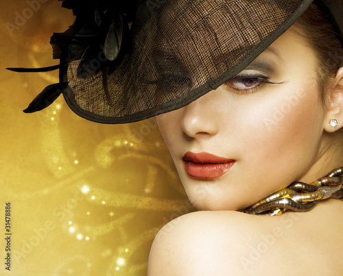 Photo: Beautiful Woman over luxury gold background Beautiful Woman over luxury gold background