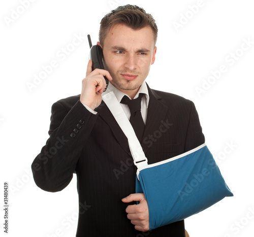 Photo: calling young businessman with broken hand, series calling young businessman with broken hand, series