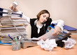 Young businesswoman with tons of documents