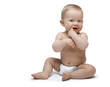 Photo: Sweet little boy sitting with finger in the mouth Sweet little boy sitting with finger in the mouth