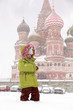 Little frozen girl standing in front of St. Basil's Cathedral