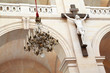 crucifix on marble column in temple and chandelier