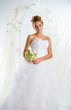 Beautiful bride with bouquet of flowers indoors