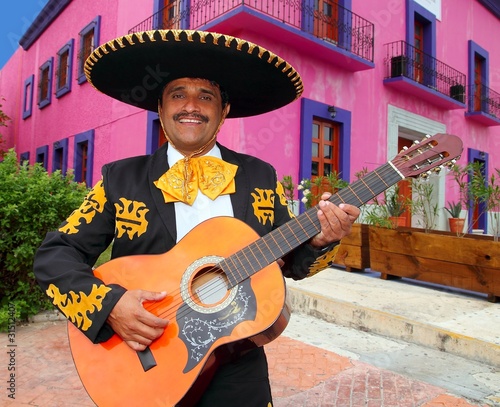 Photo : Charro Mariachi playing guitar Mexico houses Charro Mariachi playing guitar Mexico houses