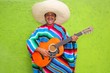 Photo : Mexican typical man playing guitar poncho Mexican typical man playing guitar poncho