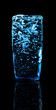 A glass of water on a black background with reflections